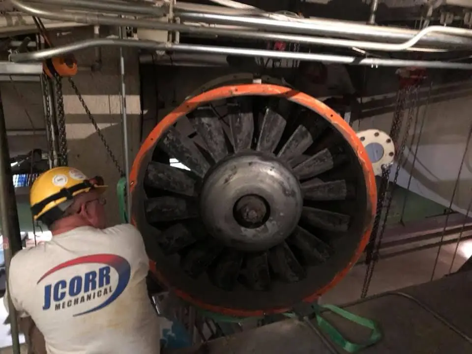 JCORR Mechanical technician servicing a large industrial fan assembly